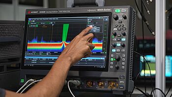 Engineer using an oscilloscope.